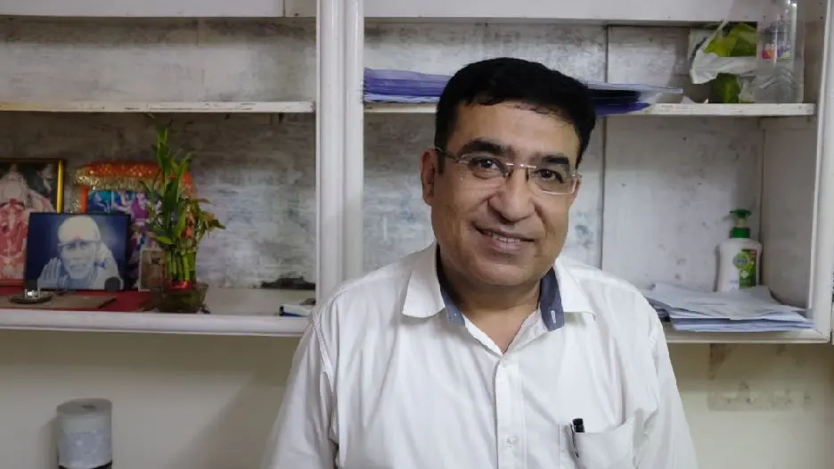 A small-business owner interviewed in his workplace